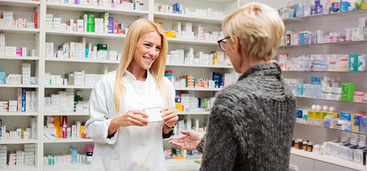 pharmacy technician explains dosage and side effects of medication to customer