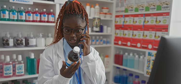 california pharmacy technician helps customer with ingredients on telephone